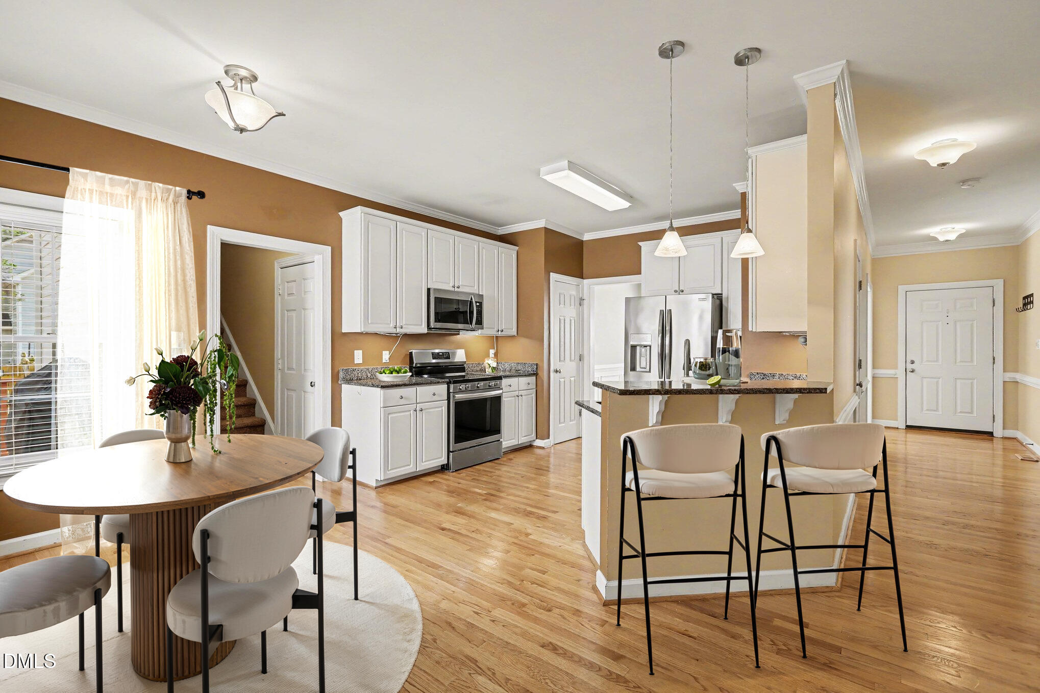 2616 Jasper Lane Raleigh, NC 27613 - Photo 11 of 44 a kitchen with stainless steel appliances kitchen island granite countertop a dining table chairs and granite counter tops