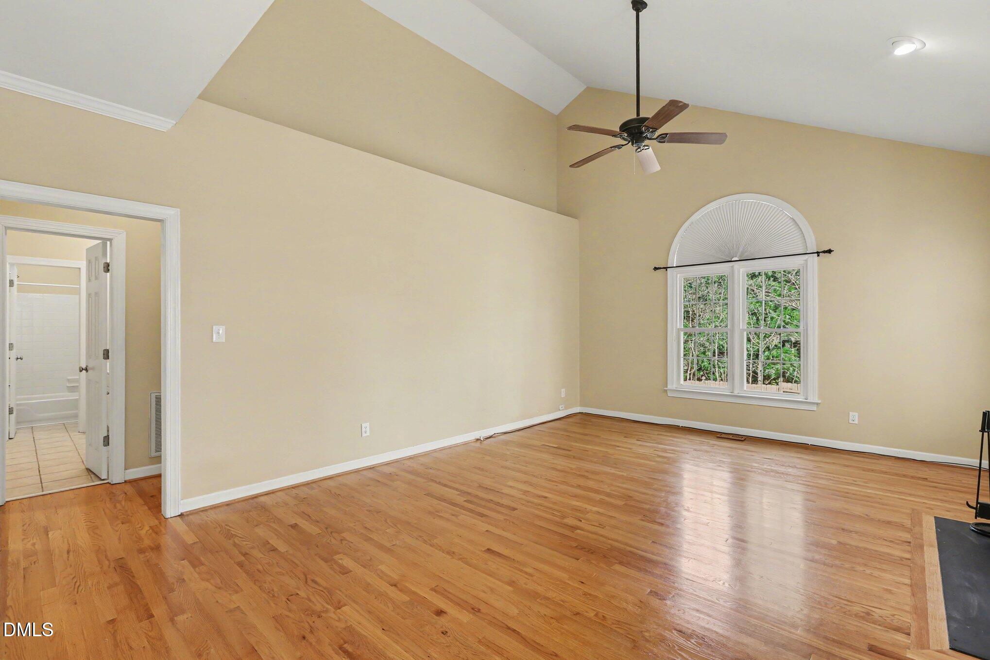 2616 Jasper Lane Raleigh, NC 27613 - Photo 25 of 44 an empty room with wooden floor fan and windows