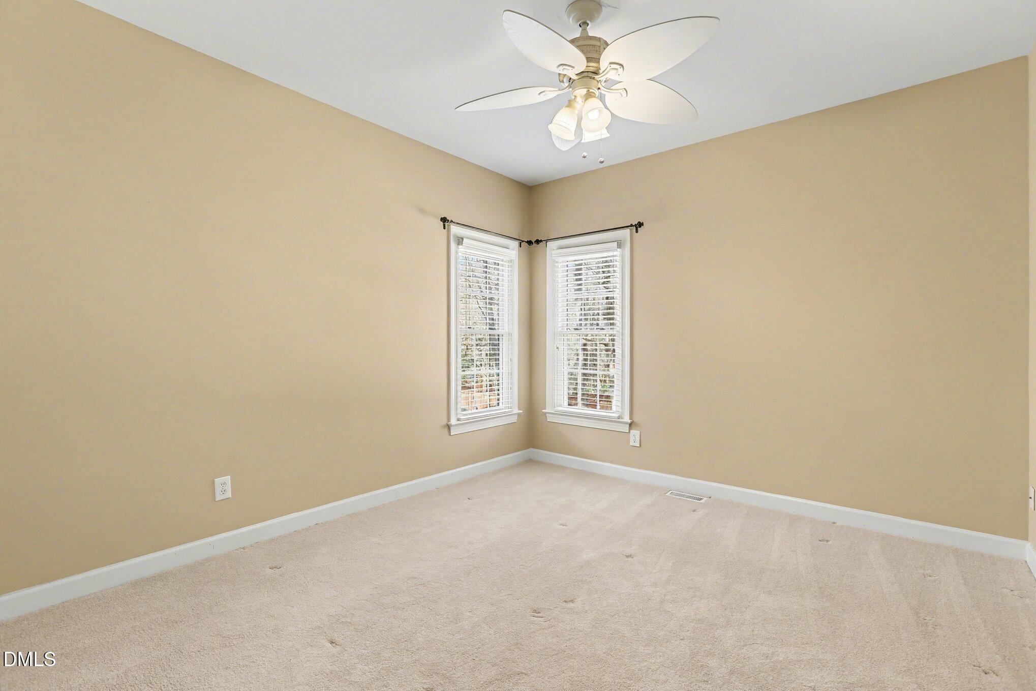 2616 Jasper Lane Raleigh, NC 27613 - Photo 27 of 44 an empty room with windows and fan