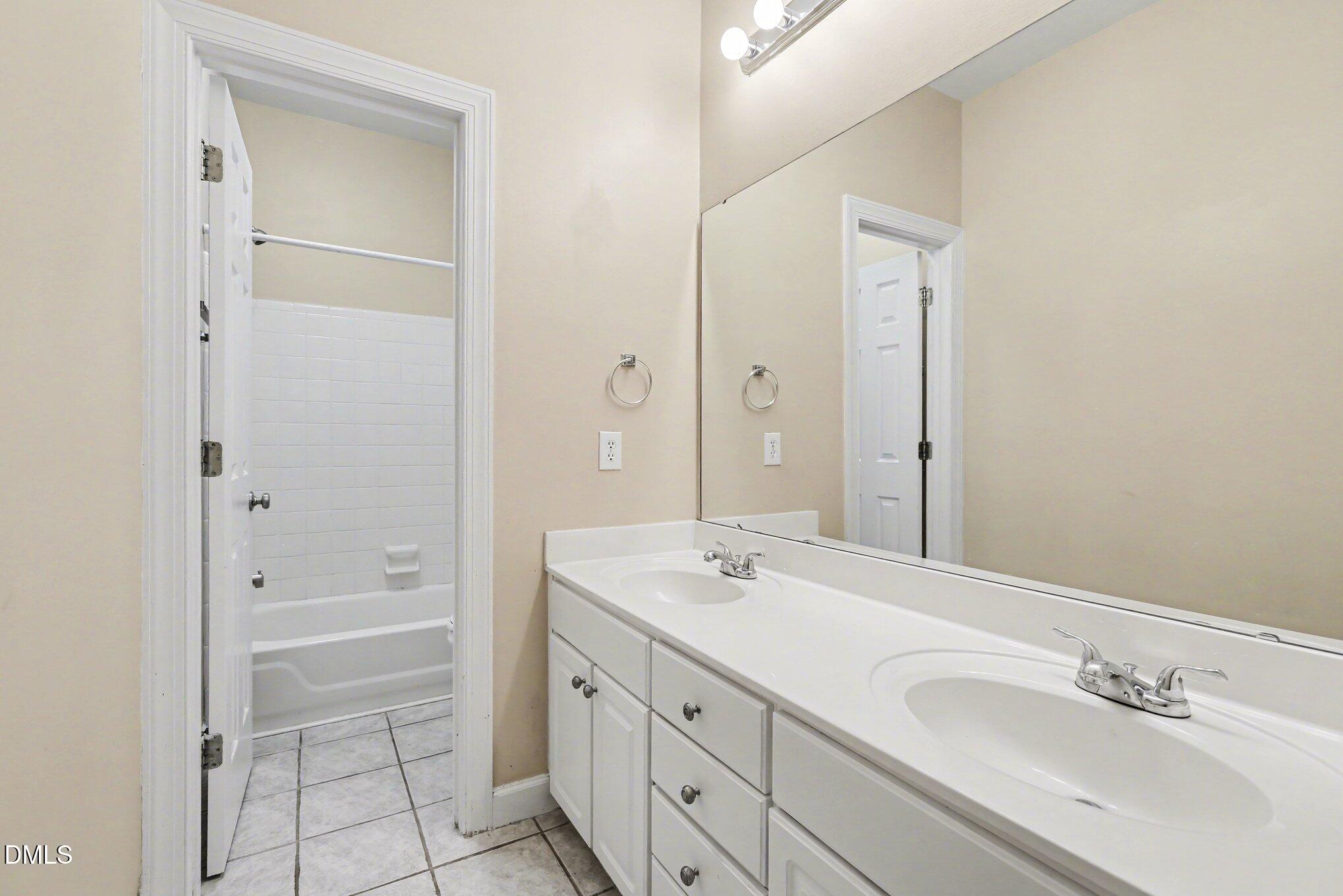 2616 Jasper Lane Raleigh, NC 27613 - Photo 30 of 44 a bathroom with a shower sink and tub