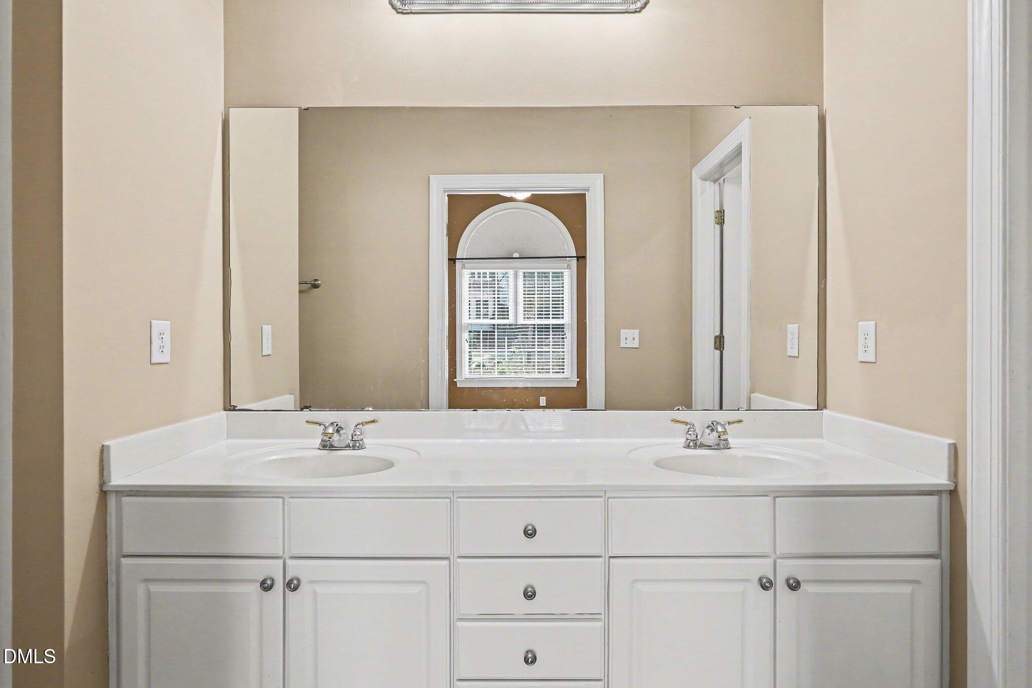 2616 Jasper Lane Raleigh, NC 27613 - Photo 35 of 44 a bathroom with a sink and two mirror