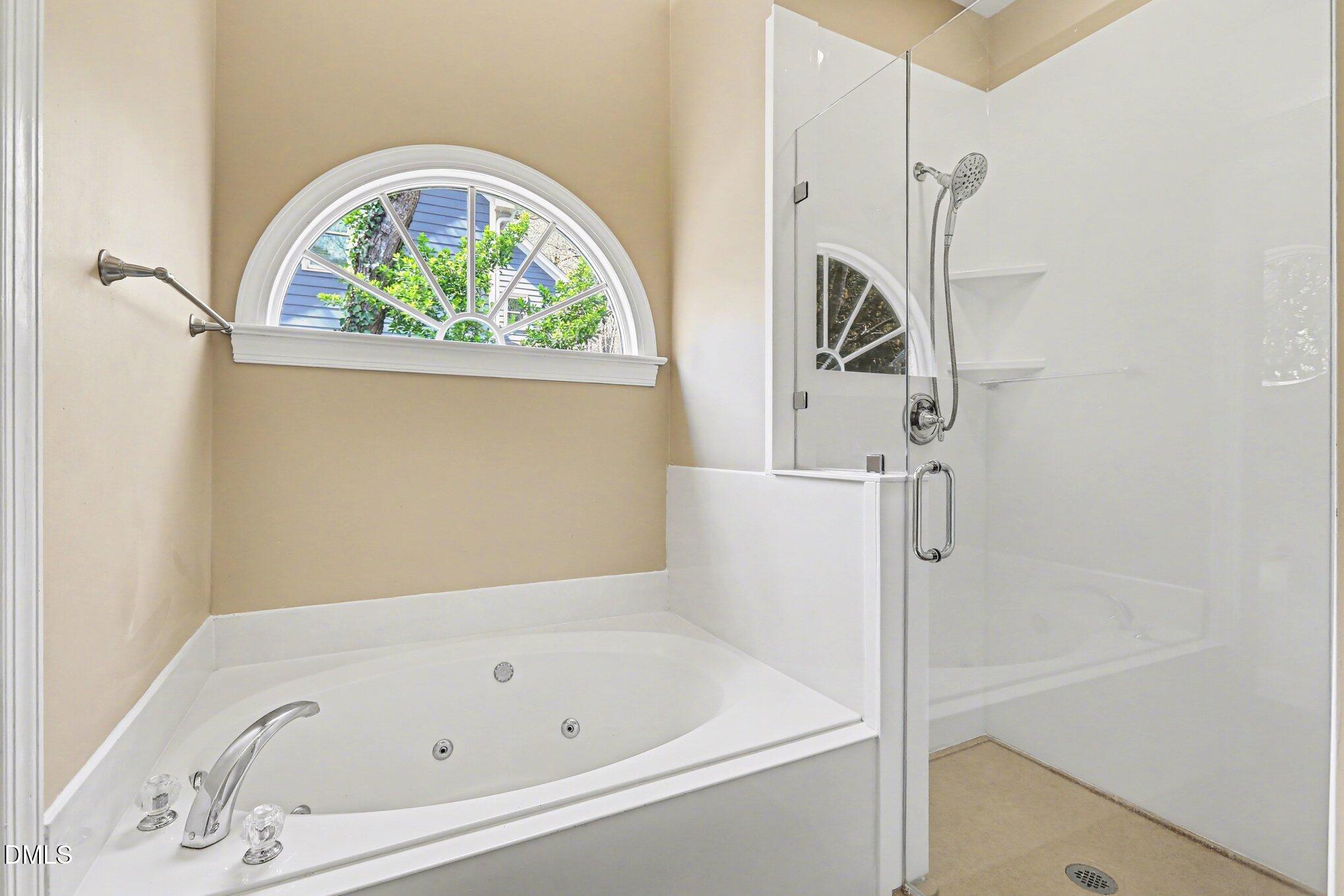 2616 Jasper Lane Raleigh, NC 27613 - Photo 36 of 44 a bathroom with a bathtub and a window