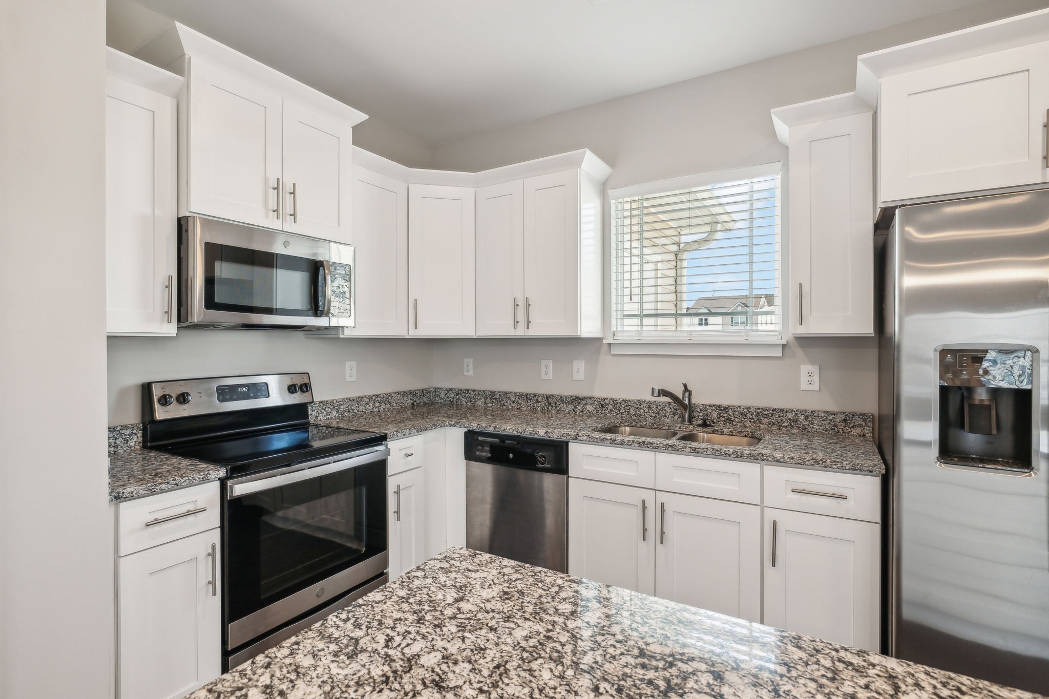 7026 Magnolia Crossings Spring Hill, TN 37174 - Photo 5 of 20 a kitchen with a sink stove and microwave
