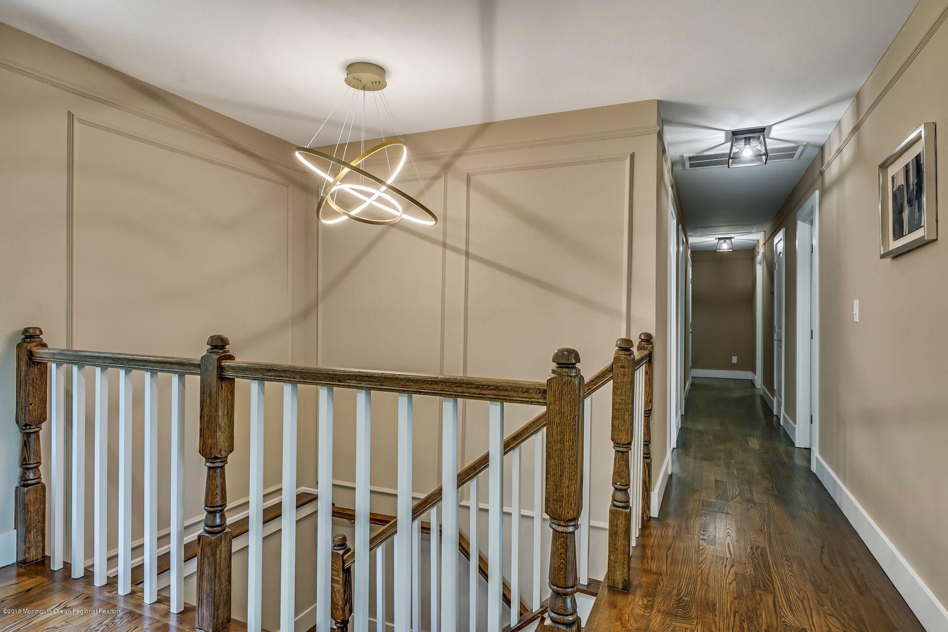 715 West Farms Road Howell, NJ 07731 - Photo 16 of 48 a view of a hallway with wooden floor and staircase