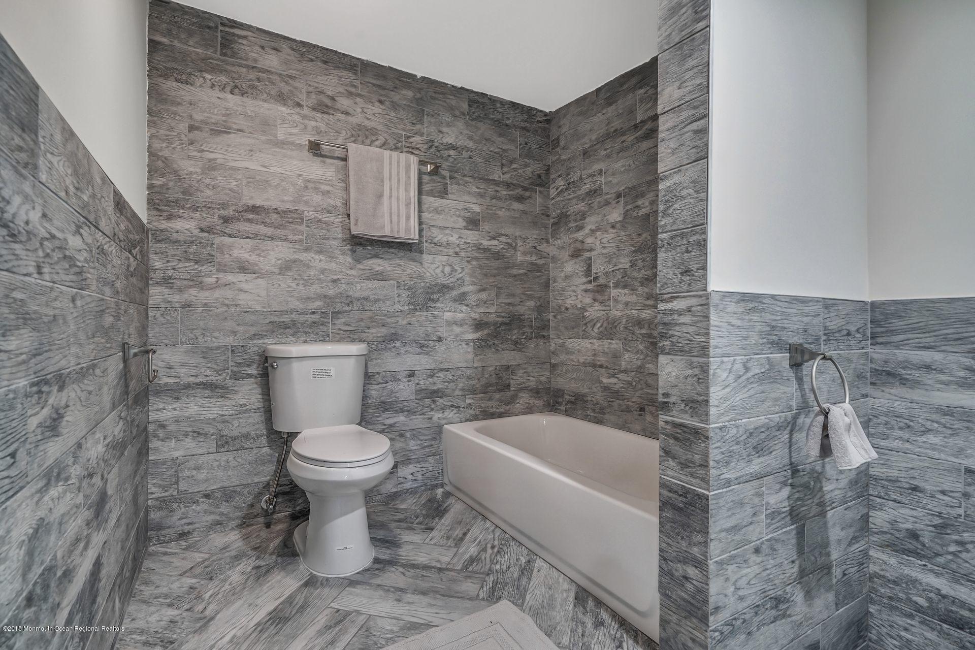 715 West Farms Road Howell, NJ 07731 - Photo 35 of 48 a white toilet sitting next to a bath tub