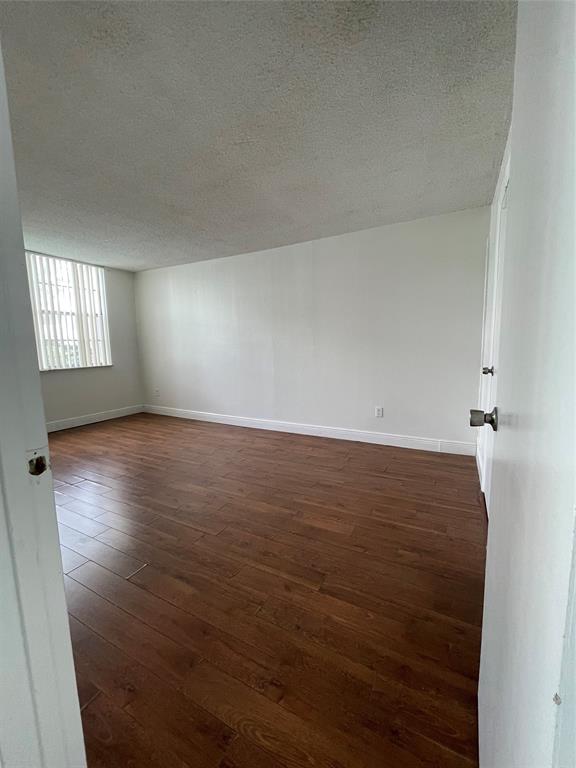 492 Northwest 165th Street Miami, FL 33169 - Photo 15 of 27 an empty room with wooden floor and windows