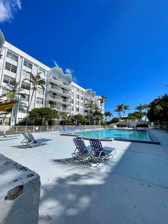 492 Northwest 165th Street Miami, FL 33169 - Photo 26 of 27 a swimming pool with outdoor seating and yard