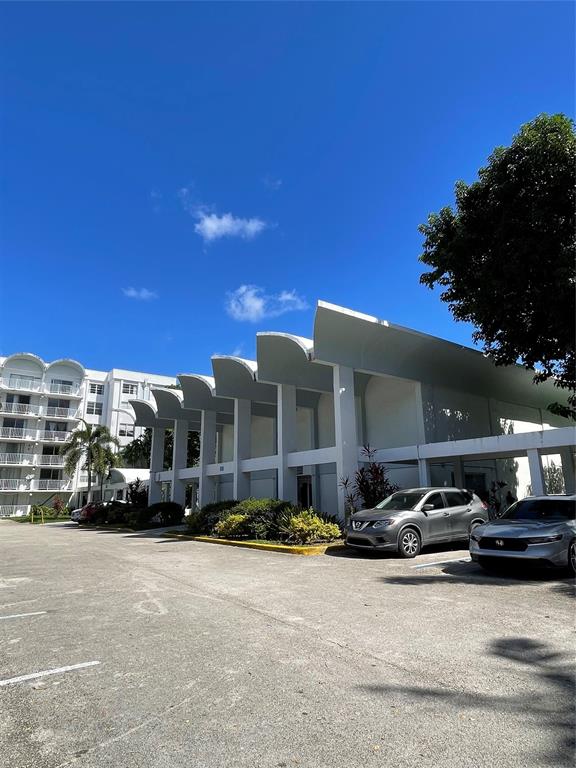 492 Northwest 165th Street Miami, FL 33169 - Photo 27 of 27 a front view of a building with cars parked