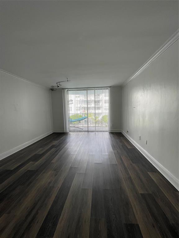 492 Northwest 165th Street Miami, FL 33169 - Photo 8 of 27 an empty room with wooden floor and windows
