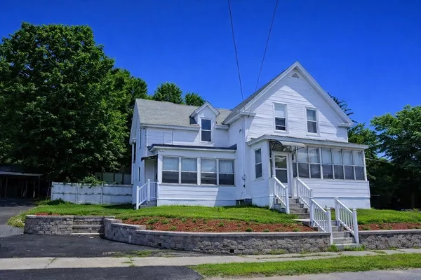 a front view of a house with a yard