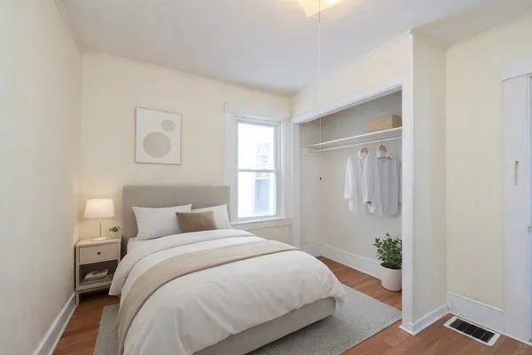 a bedroom with a bed and a window