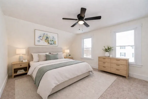 a bedroom with a bed and a window