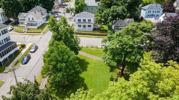 an aerial view of residential houses with yard and swimming pool