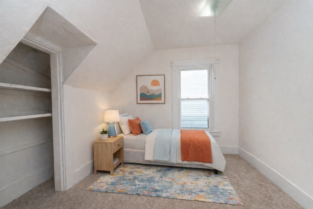 85 Beacon Street Clinton, MA 01510 - Photo 22 of 39 a bedroom with a bed and wooden floor