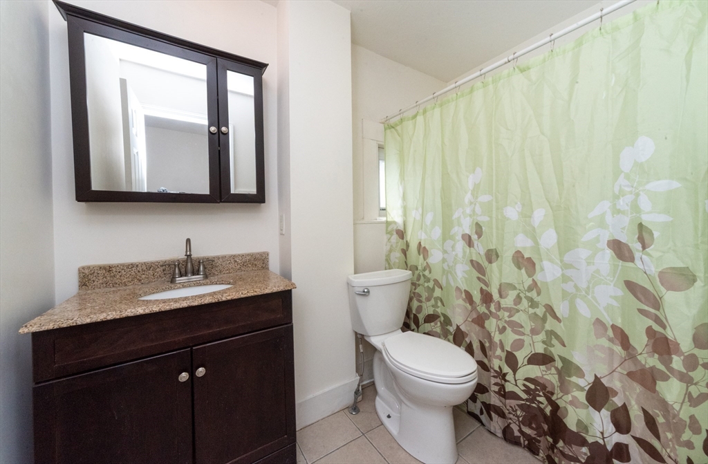 85 Beacon Street Clinton, MA 01510 - Photo 24 of 39 a bathroom with a granite countertop sink toilet and mirror