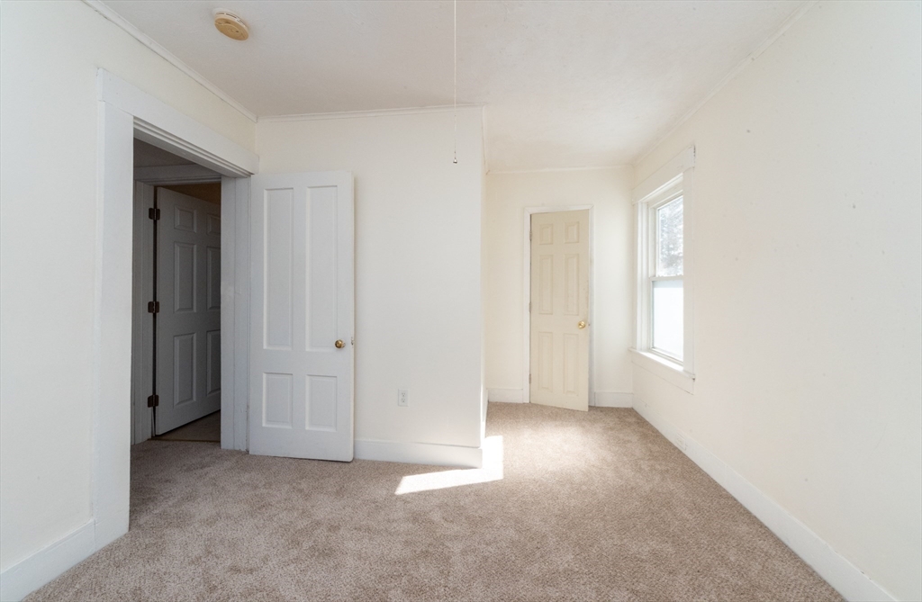 85 Beacon Street Clinton, MA 01510 - Photo 29 of 39 an empty room with windows and closet