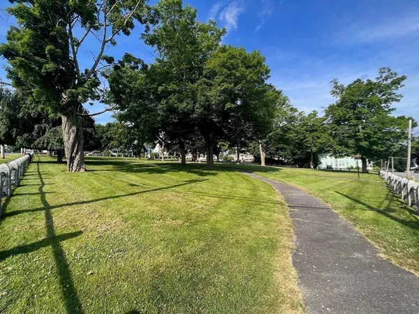 an aerial view of residential houses with outdoor space and swimming pool