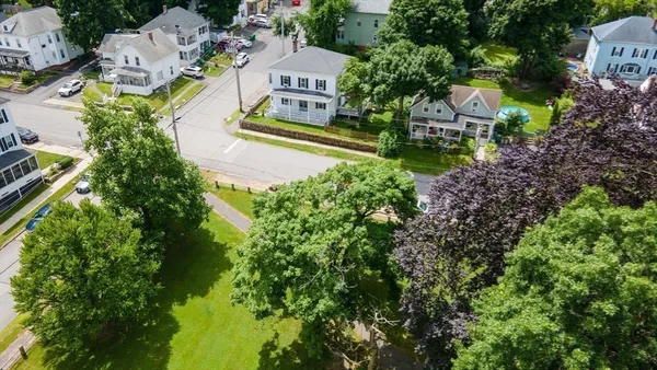 an aerial view of residential houses with outdoor space