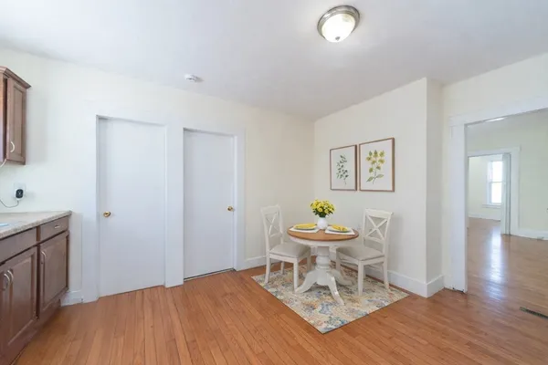 a living room with a sink and a wooden floor