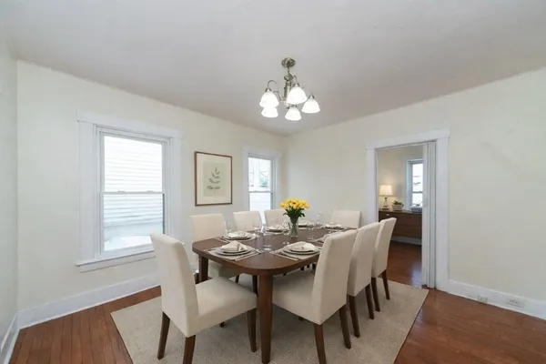 a view of a dining room with a table and chairs