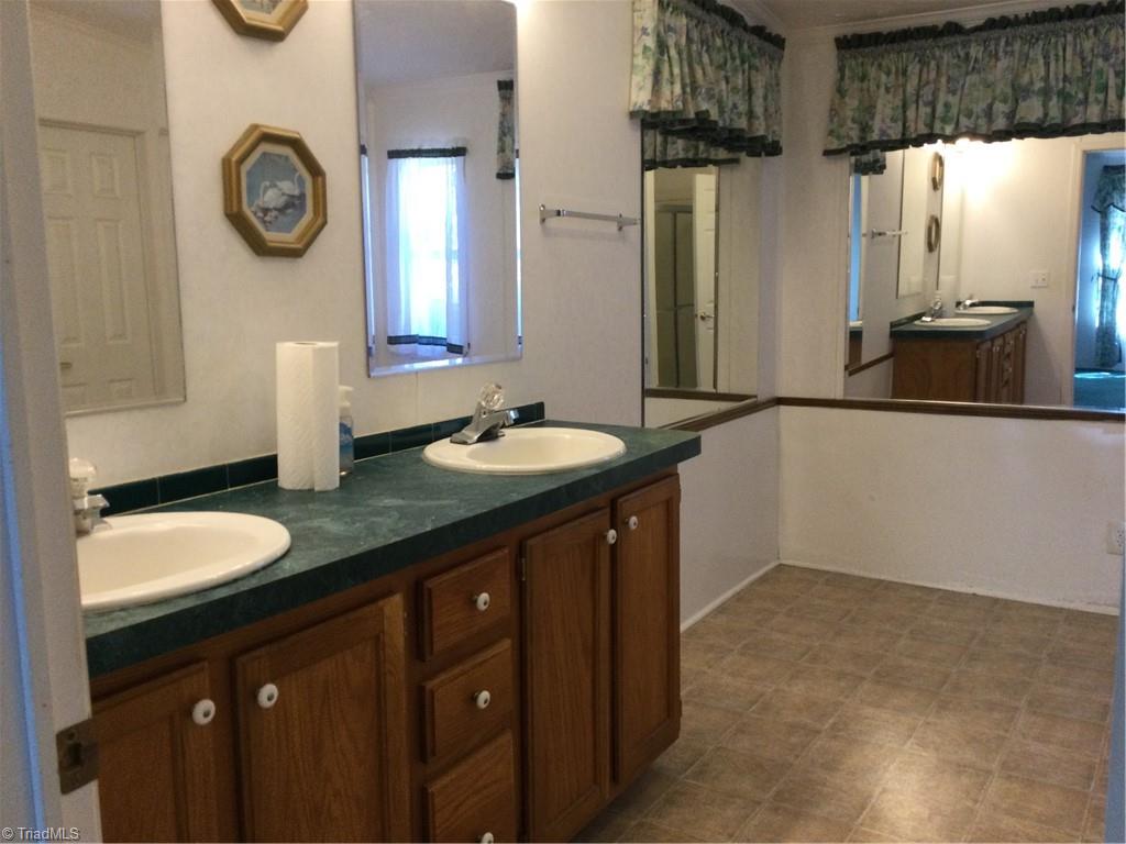 1027 Old Wagon Road King, NC 27021 - Photo 16 of 35 Primary bath has double vanity, linen closet and room for extras