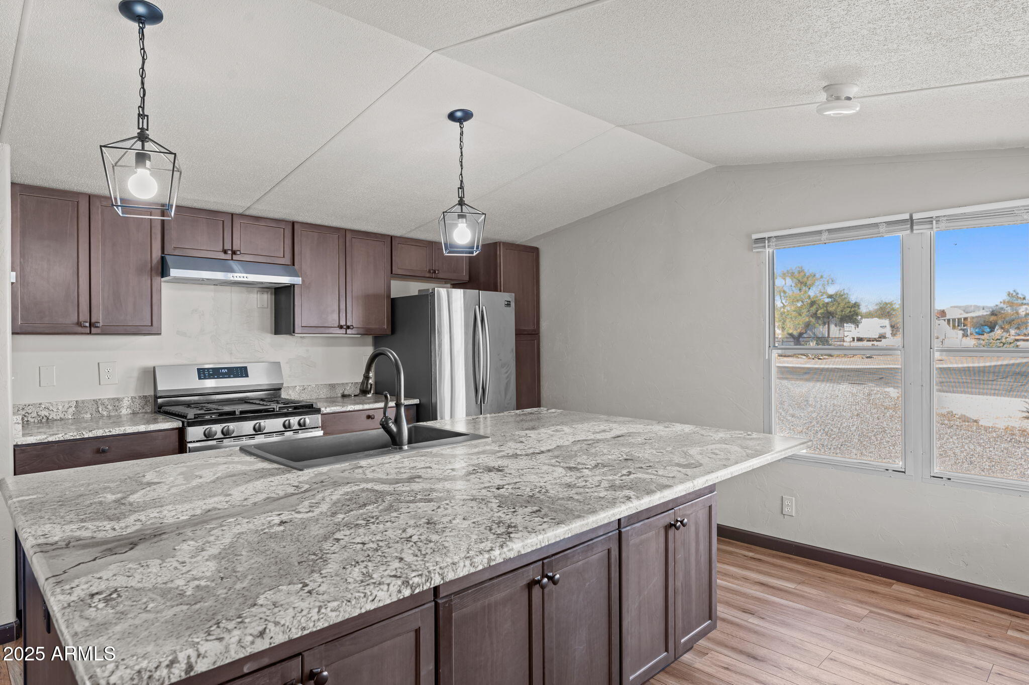 21199 West Escapee Way Congress, AZ 85332 - Photo 1 of 23 a kitchen with stainless steel appliances granite countertop a sink a stove and a wooden floors