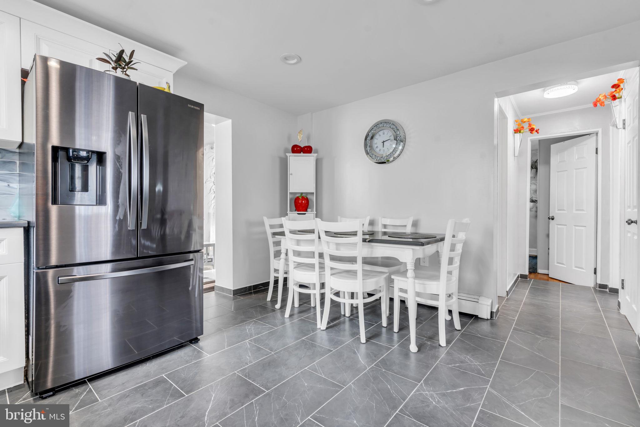 80 Locust Avenue Hamilton, NJ 08620 - Photo 10 of 24 a dining room with furniture a kitchen and a refrigerator