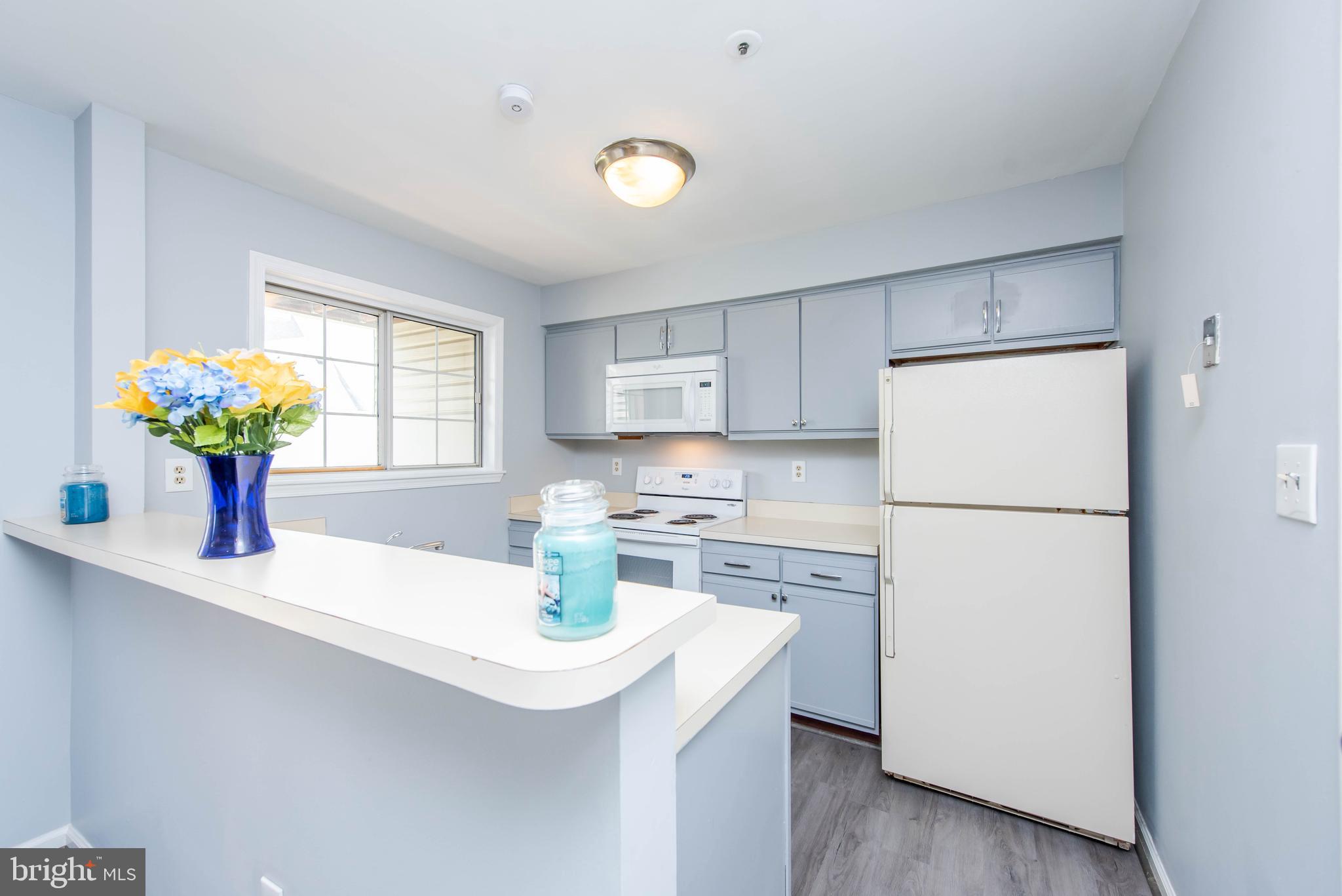 7902 Crows Nest Court, Unit 345 Laurel, MD 20707 - Photo 2 of 35 Kitchen w/ breakfast bar and updated cabinets