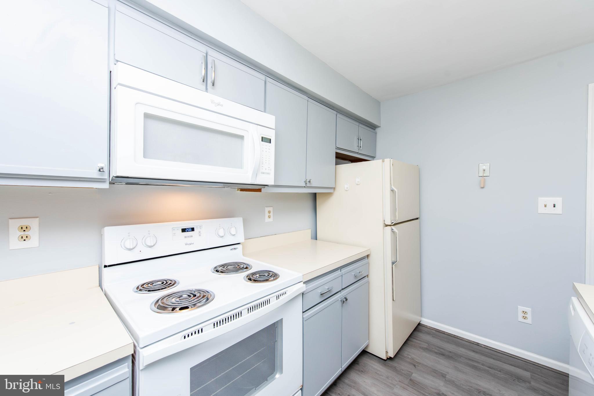 7902 Crows Nest Court, Unit 345 Laurel, MD 20707 - Photo 4 of 35 Kitchen w/updated stove, microwave & dishwasher.