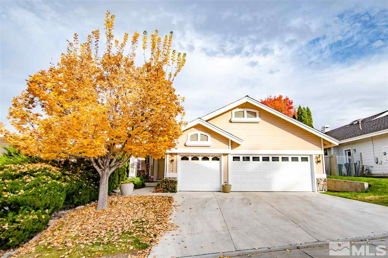 6174 Carriage House Way Reno, NV 89519 - Photo 1 of 22 a view of a white house with a large tree and wooden fence