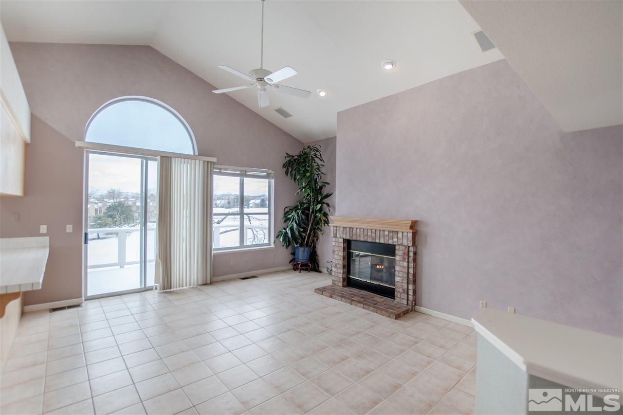 6174 Carriage House Way Reno, NV 89519 - Photo 11 of 22 a view of an empty room with a fireplace and a window