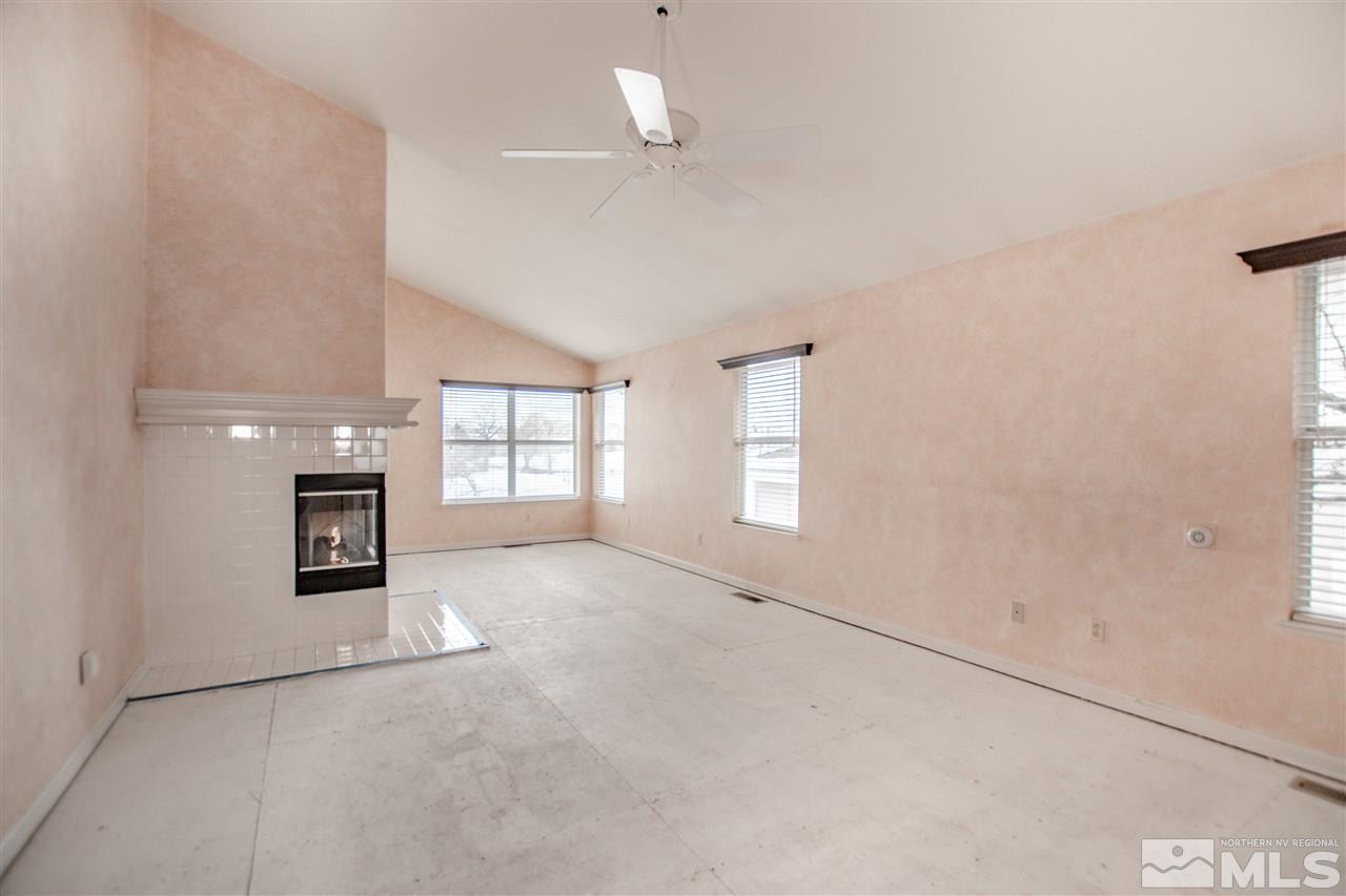 6174 Carriage House Way Reno, NV 89519 - Photo 13 of 22 an empty room with windows and fireplace