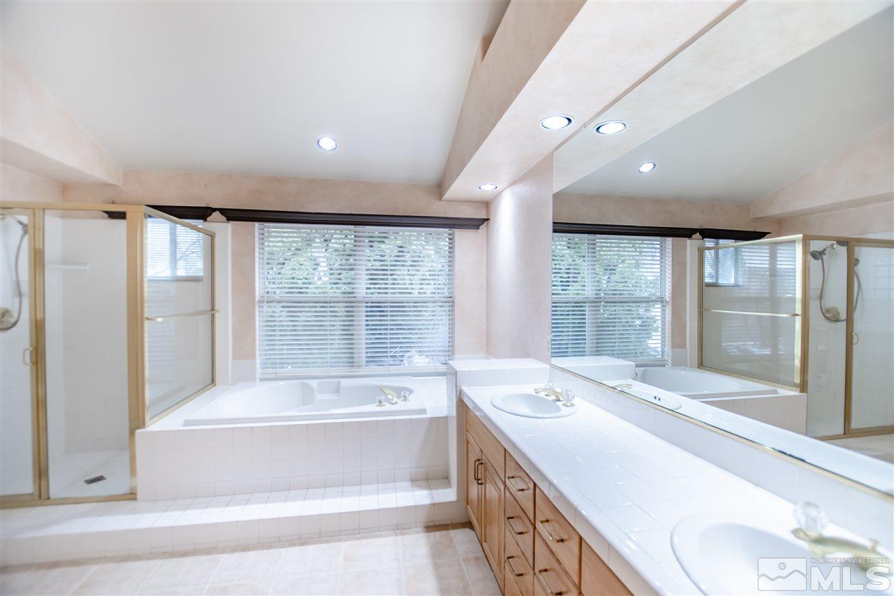 6174 Carriage House Way Reno, NV 89519 - Photo 14 of 22 a spacious bathroom with a large tub and large window