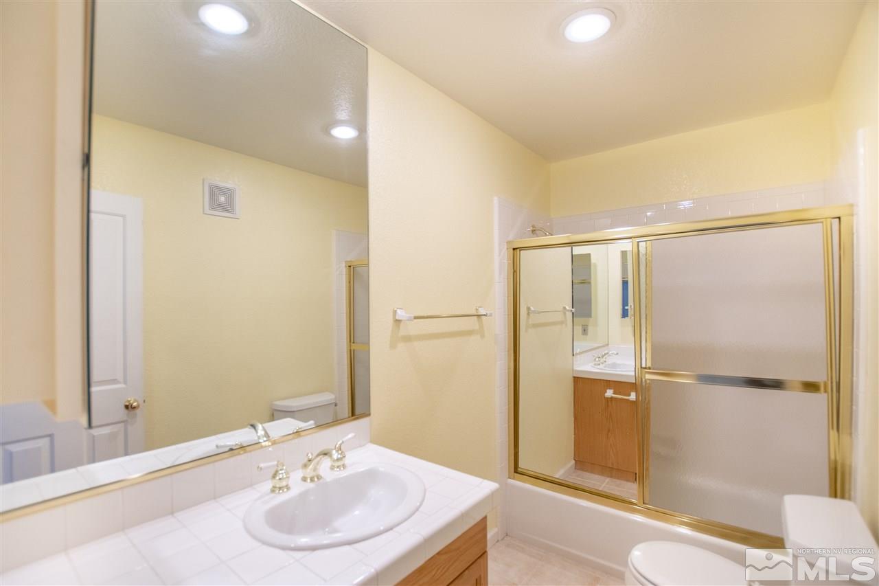 6174 Carriage House Way Reno, NV 89519 - Photo 20 of 22 a bathroom with a sink and a mirror