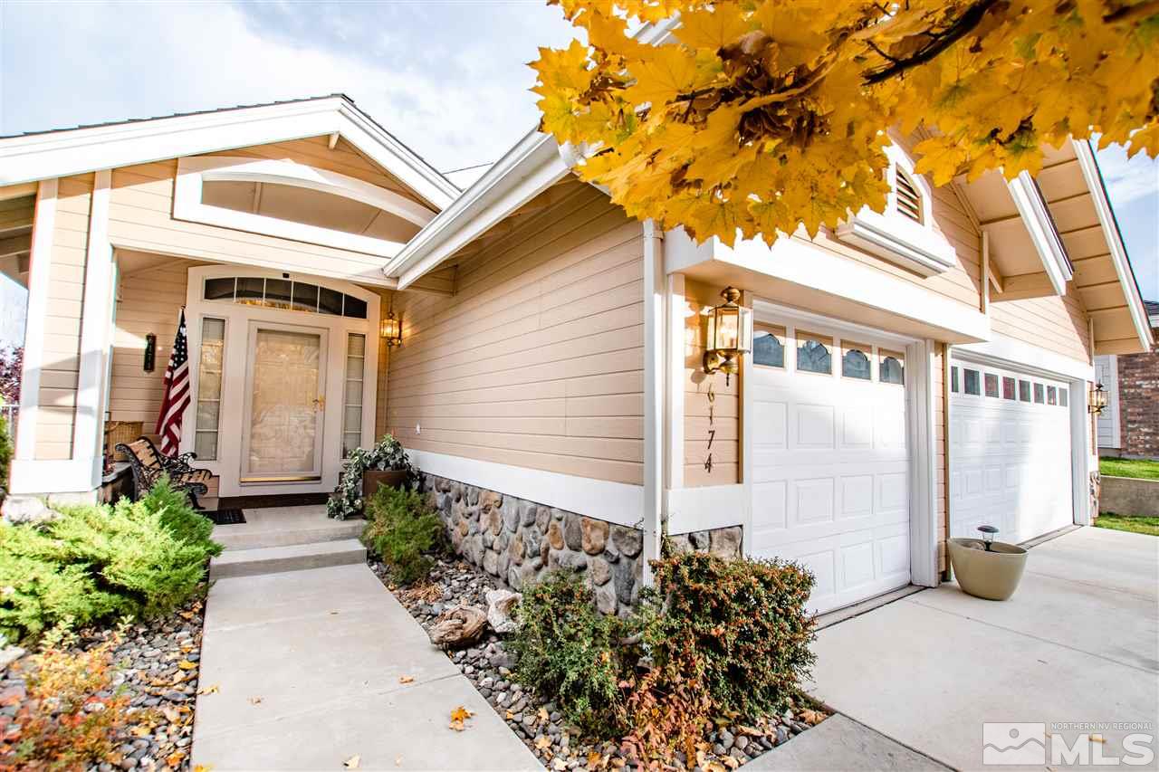 6174 Carriage House Way Reno, NV 89519 - Photo 2 of 22 a front view of a house with garden