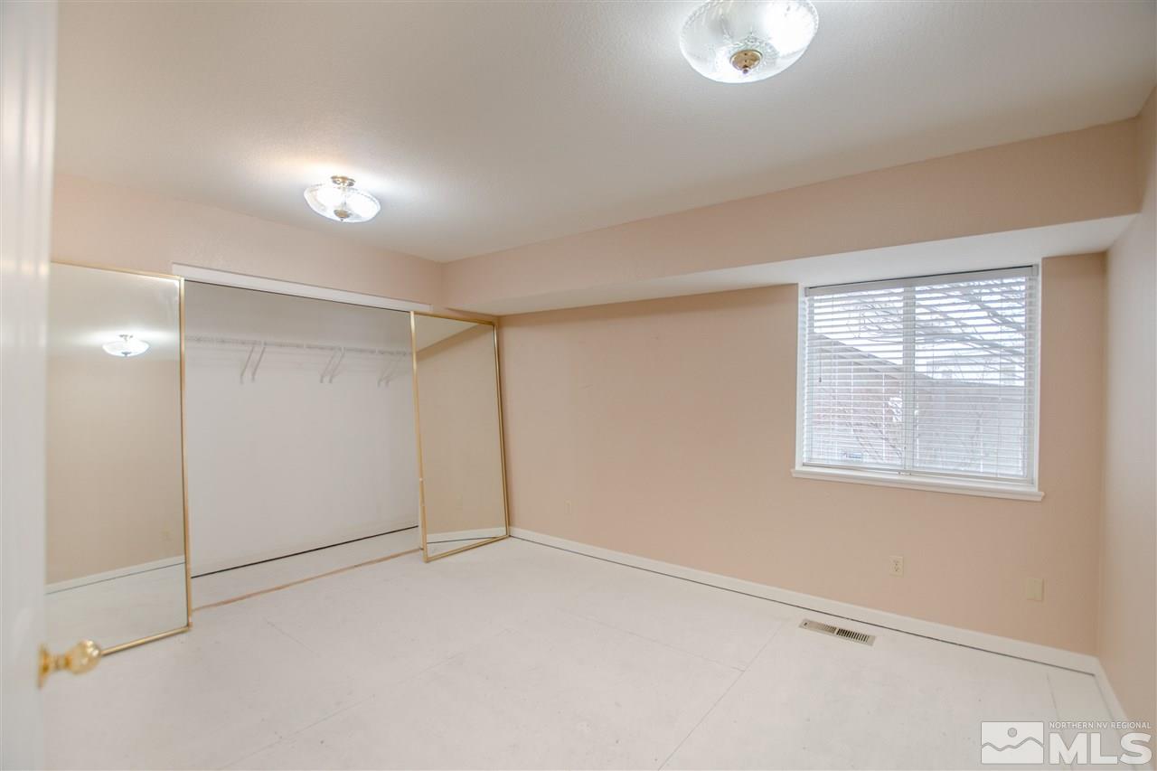 6174 Carriage House Way Reno, NV 89519 - Photo 21 of 22 an empty room with windows and closet