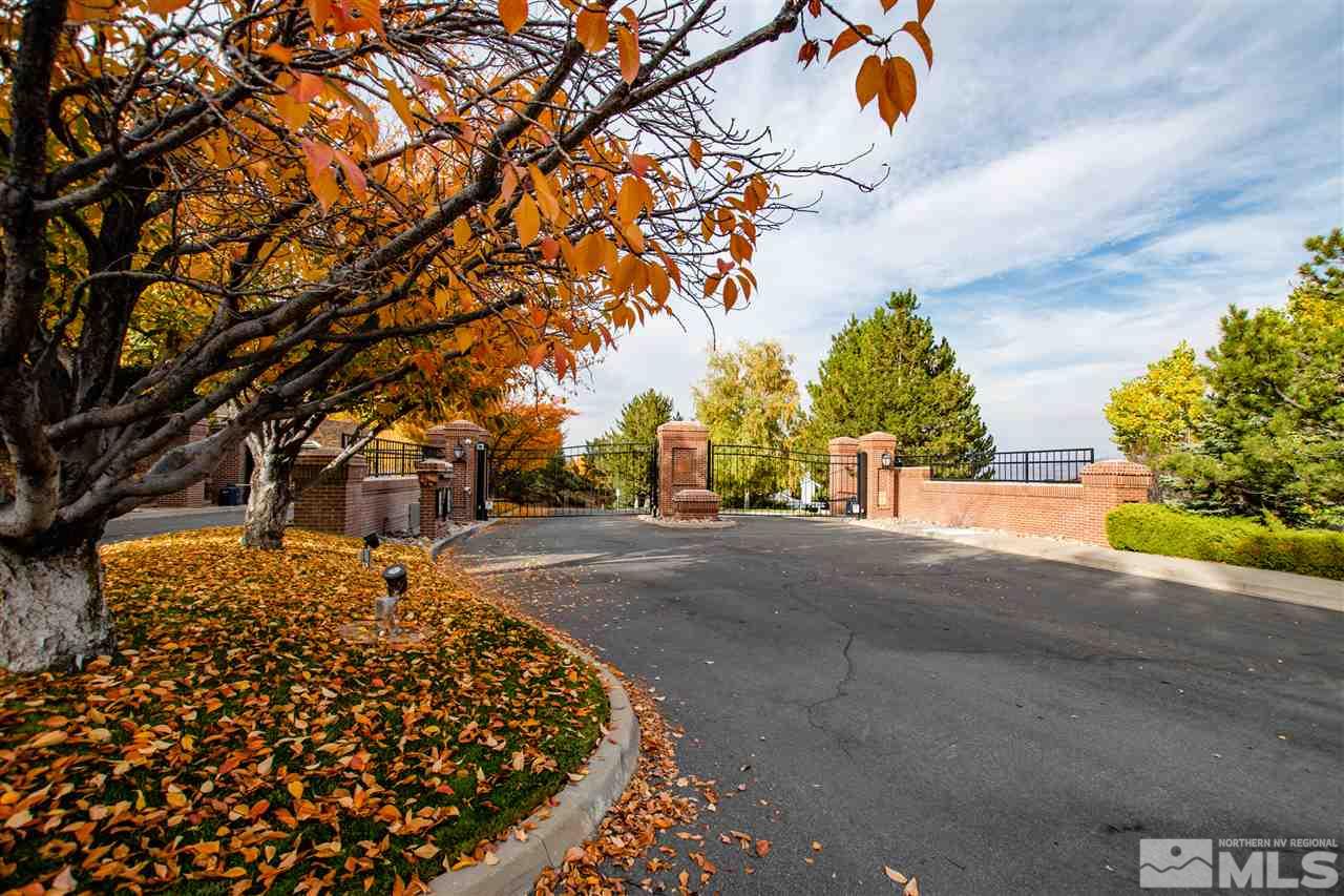 6174 Carriage House Way Reno, NV 89519 - Photo 3 of 22 a sign board with a yard and large trees