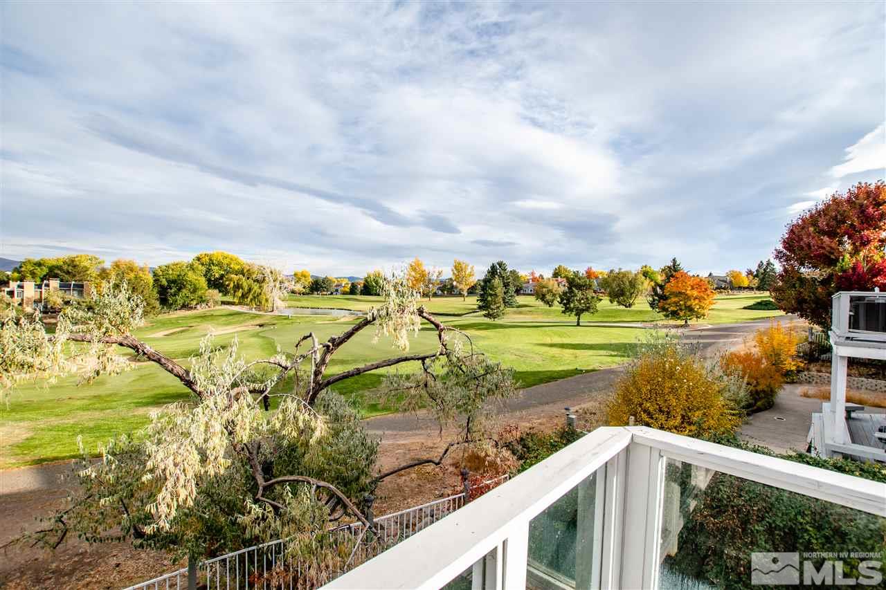 6174 Carriage House Way Reno, NV 89519 - Photo 4 of 22 a view of a lake with a yard