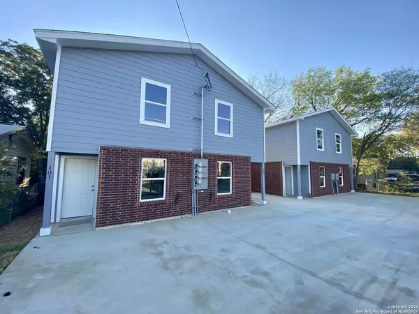 a view of a house with a yard and garage