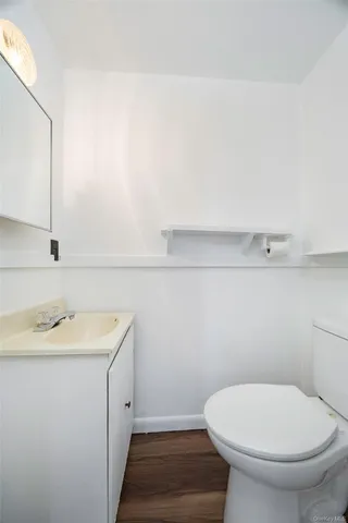 a bathroom with a toilet a sink and mirror