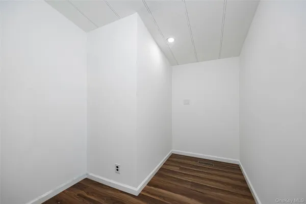 a view of room with wooden floor