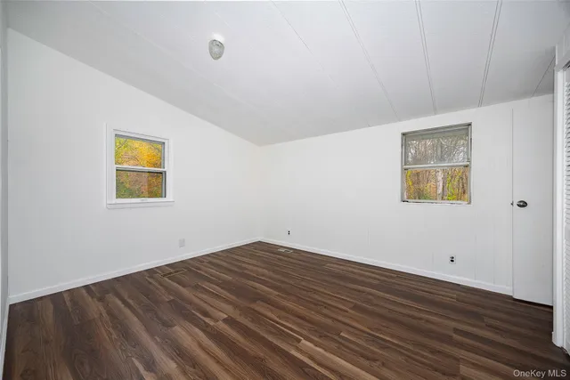 a view of a room with wooden floor and windows