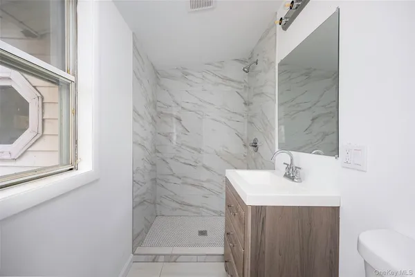 a bathroom with a sink a mirror and shower