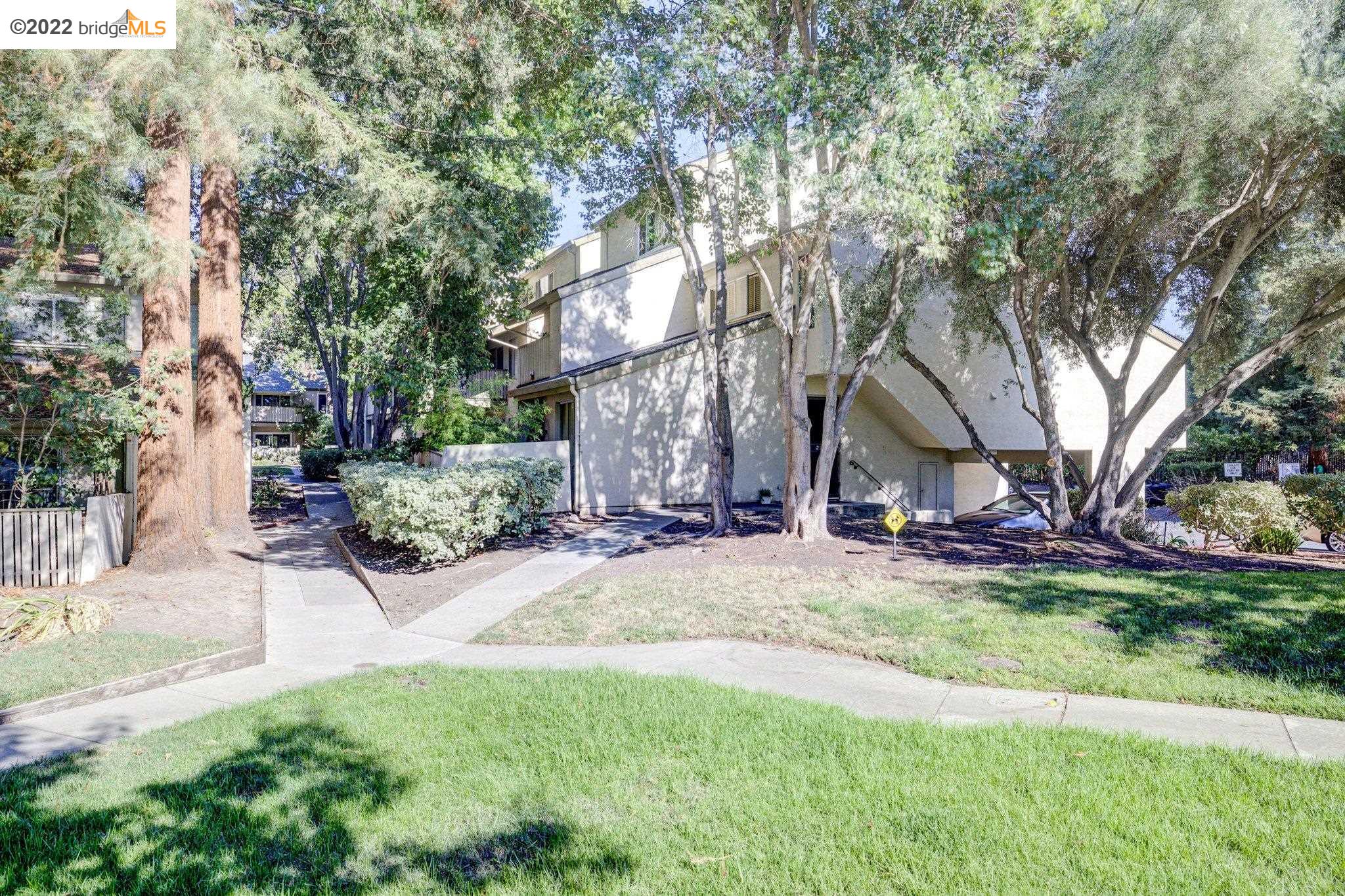 2704 Oak Road, Unit 71 Walnut Creek, CA 94597 - Photo 1 of 1 a view of a house with a yard and tree