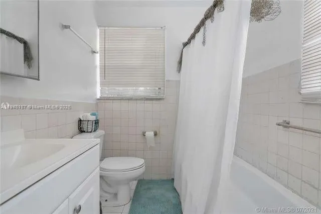 a bathroom with a toilet sink and shower