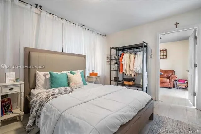 a bed room with a bed and a large mirror