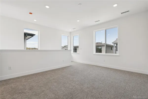 a view of an empty room with a window and fireplace