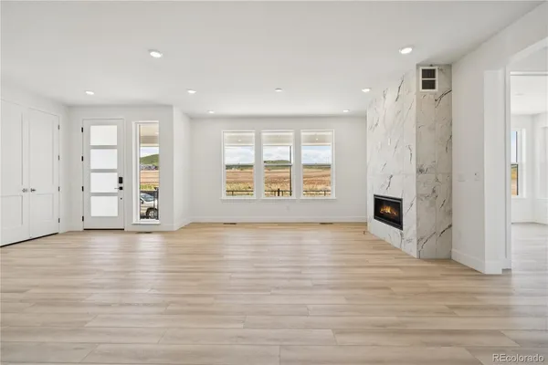 a view of entryway and hall with wooden floor