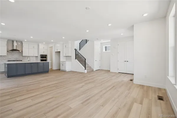 a kitchen with stainless steel appliances granite countertop a sink a stove and a refrigerator