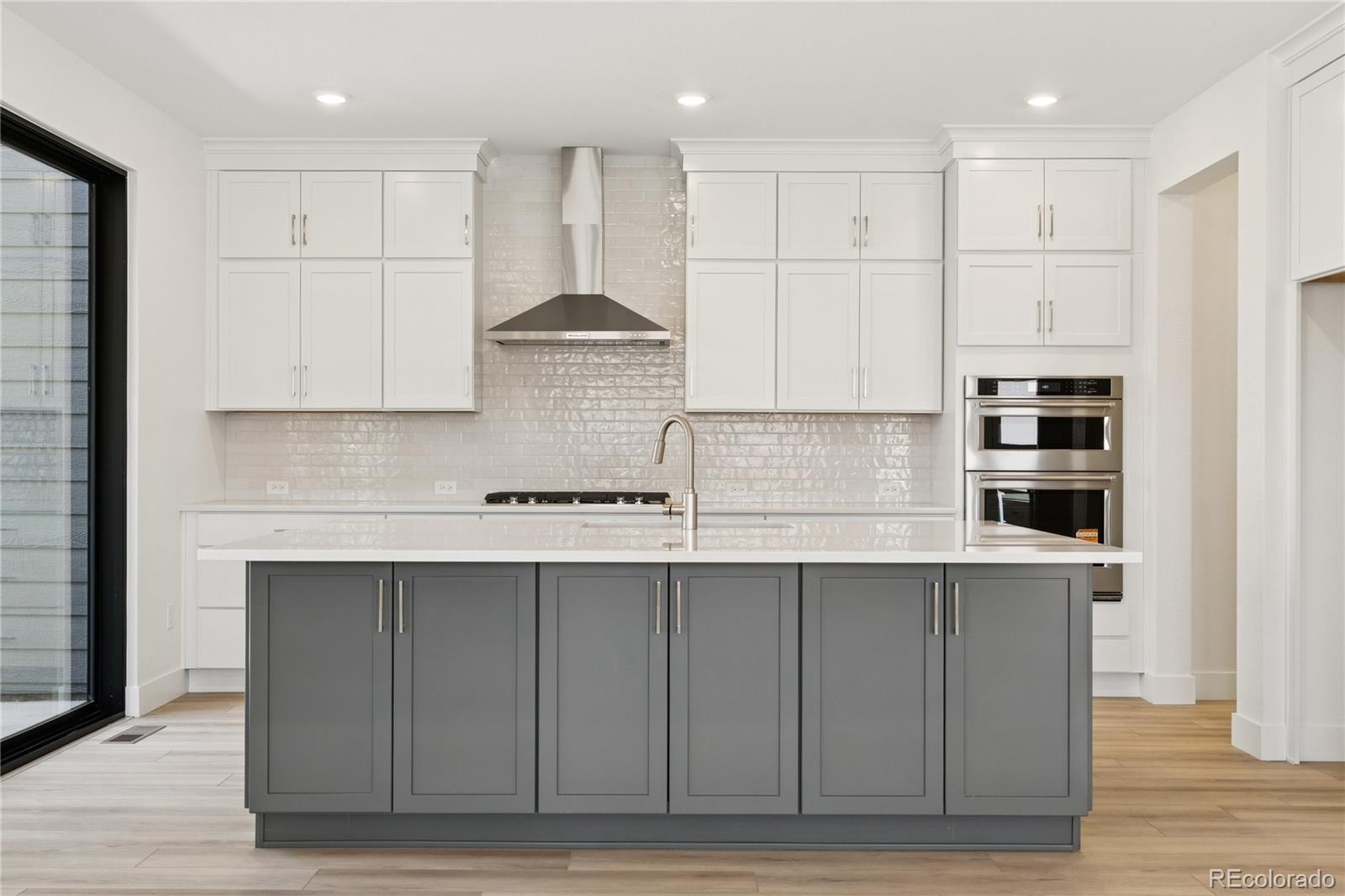 11196 Vibrato Lane Lone Tree, CO 80134 - Photo 20 of 45 a kitchen with stainless steel appliances granite countertop a sink a stove and a refrigerator